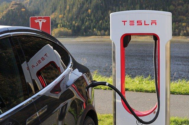 Tesla charging at charging station